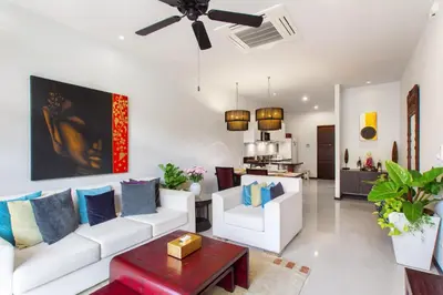 a living room with white furniture and a ceiling fan at Stylish 3BR Pool Villa Onyx H4, Gated Residence, Near Rawai & Naiharn Beach in Rawai Beach