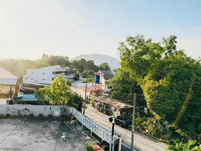 an overhead view of a street with trees and buildings at Siray House in Phuket Town