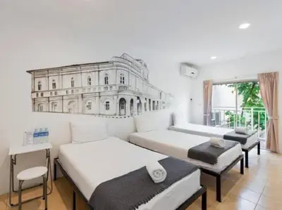 two beds in a room with a drawing on the wall at Chino Town Gallery Alley - SHA Plus in Phuket Town