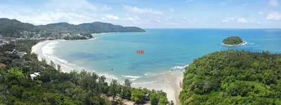 an aerial view of a beach with trees and the ocean at Kata Beach Luxury Condo - Spacious - Exquisitely Furnished - 6min walk to beach - 2025 Booking Traveller Award Winner in Kata Beach