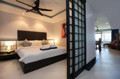 a bedroom with a bed with a ceiling fan at Kata Beach Luxury Condo - Spacious - Exquisitely Furnished - 6min walk to beach - 2025 Booking Traveller Award Winner in Kata Beach