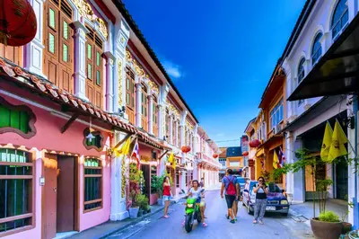 a group of people walking down a street with buildings at Large Apartment In Lovely Panwa - All Welcome! in Ban Ao Makham
