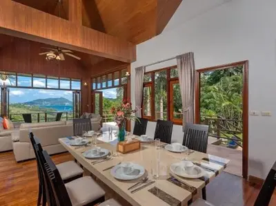 a dining room with a table and some chairs at Patonghill estate 6 bedroom sea view in Patong Beach