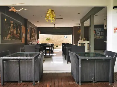 a restaurant with tables and chairs and a chandelier at Luxury 2 Bedroom Private Pool Villa in Kamala Walk to Beach Shops and Dining in Kamala Beach