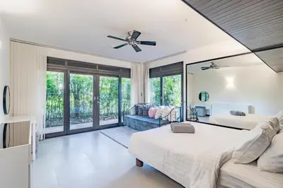 a bedroom with two beds and a couch at 3BR Casa Oasis - Beachfront Home in Laguna & Layan Chom Tawan and Maan Tawan Residences in Phuket Town