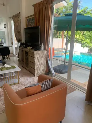 a living room with a couch and a tv at Villa du Bonheur Mer et Nature Rawai beach in Phuket Town