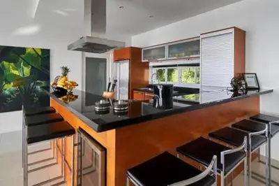 a kitchen with a black counter top in a room at Villa Ginborn 5 bedroom Pool Villa with Sea View in Kata Beach in Kata Beach