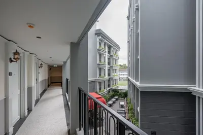 a corridor of a building with a balcony at Chateau Du Village Patong in Patong Beach