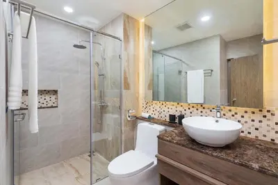a bathroom with a toilet and a sink and a shower at Appartements avec piscine in Rawai Beach