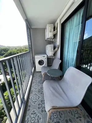 a balcony with two chairs and a table and a window at A3 Руб ВАТСАП669З582I976 in Phuket Town