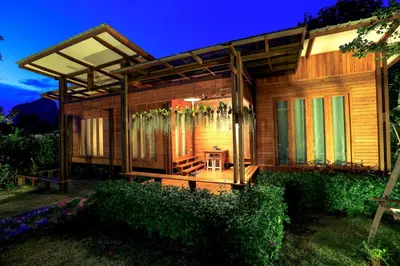 a wooden house with a table in front of it at Viangviman Luxury Resort, Krabi in Ao Nang Beach