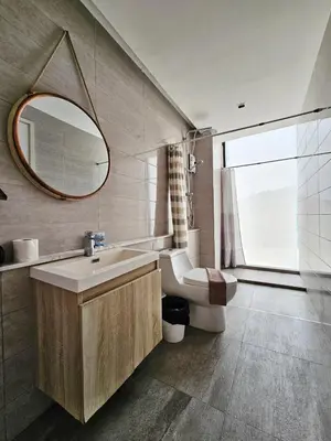 a bathroom with a sink and a mirror at Duplex Pool Access 2brs Patong in Patong Beach