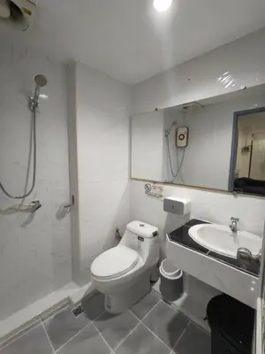 a bathroom with a toilet and a sink at Cozy Patong studio apartment in Patong Beach