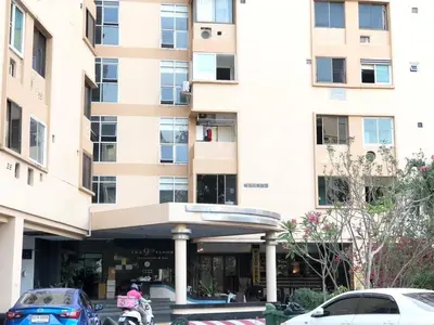 a building with cars parked in front of it at Cozy Patong studio apartment in Patong Beach