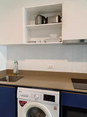 a kitchen with a washing machine and a sink at The base central phuket in Phuket Town