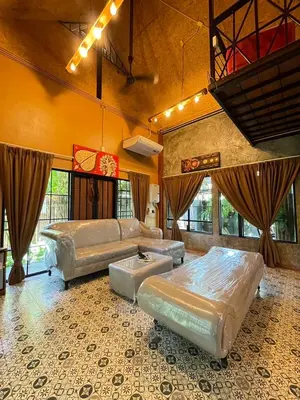 a large room with two beds and a couch at Baibon1 Boutique House Thalang Phuket in Ban Na Nai