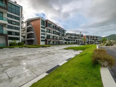 an empty parking lot in front of apartment buildings at Naithon Beachfront Condotel in Nai Thon Beach