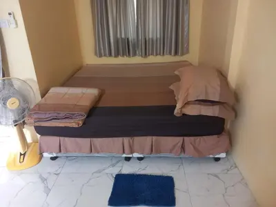 a small bed in a small room with a window at Kathu Waterfall Bungalow Holyday home in Ban Huai Luk (1)