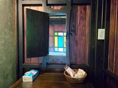 a room with a window and a basket on a table at Baan Koh Kwang Pool Villa Krabi in Krabi town