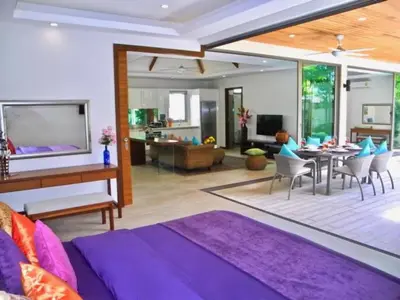 a living room with a purple couch and a dining room at Rawai Beach Private Pool Villa -3 Bedrooms in Rawai Beach