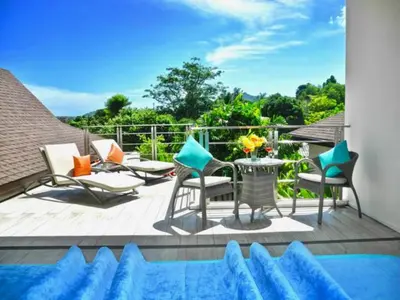 a deck with chairs and a table and a pool at Rawai Beach Private Pool Villa -3 Bedrooms in Rawai Beach