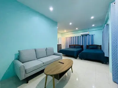 a living room with a couch and a table at NUN GUEST HOUSE in Ban Bo Han