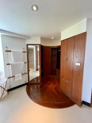 a bathroom with a large wooden cabinet and towels at Kata Sea View Sanctuary in Kata Beach