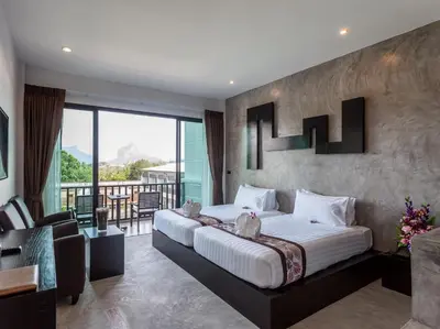 a bedroom with a large bed and a balcony at Aonang Viva Resort - SHA Plus in Ao Nang Beach
