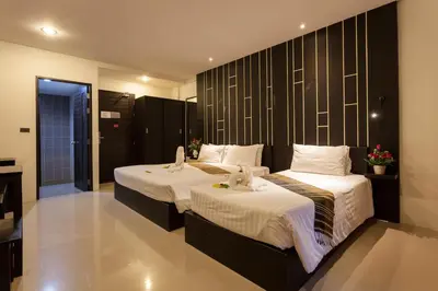 a hotel room with two beds with towels on them at Aonang Viva Resort - SHA Plus in Ao Nang Beach