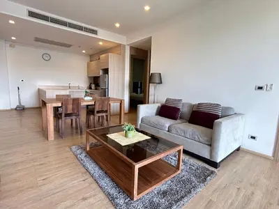a living room with a couch and a table at 2 Bedroom Beachfront Apartment With Sea Views in Mai Khao Beach