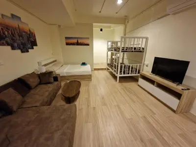 a living room with a couch and a flat screen tv at Bonanza Patong Beach1 100m to Beach Star Room in Patong Beach