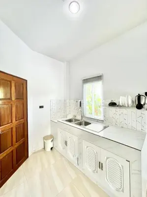 a white kitchen with a sink and a window at Lay Back Villa C2 with Kitchen & High speed Internet in Krabi town