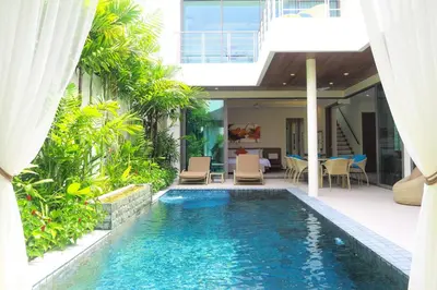 a swimming pool in the middle of a house at 4 Bedrooms Private Pool Villa near Rawai Beach in Rawai Beach