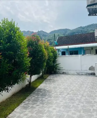 a house with a stone driveway in front of a building at Arin Townhome @Bangtao in Ban Thalat Choeng Thale