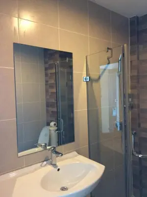 a bathroom with a sink and a shower with a mirror at XX GO INN Aonang Beach โกอินน์ หาดอ่าวนาง in Ban Khlong Haeng