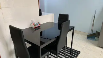 a black table and chairs in a room at Apartment in Rawai in Rawai Beach