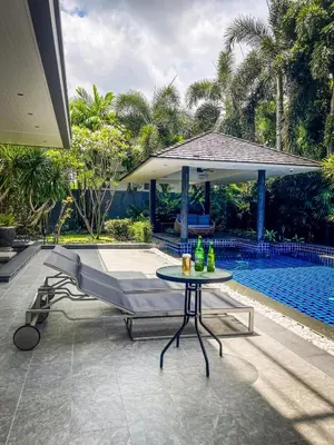 a patio with a table next to a pool at Tropical Haven 4 Bedroom Pool Villa in Bang Tao Beach
