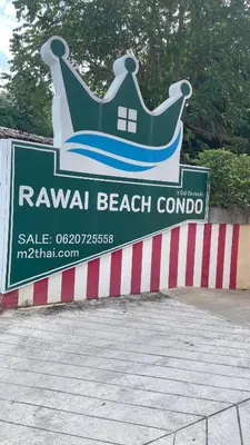 a sign for a beach club with a crown on it at Rawai beach condominium Phuket in Nai Harn Beach
