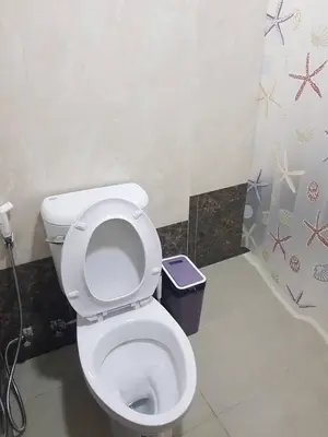 a bathroom with a toilet and a trash can at Rawai beach condominium Phuket in Nai Harn Beach