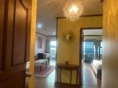 a hallway with a room with a bed and a chandelier at PATONG TOWER SEA FACING HIGH FLOOR New Bathroom in Patong Beach
