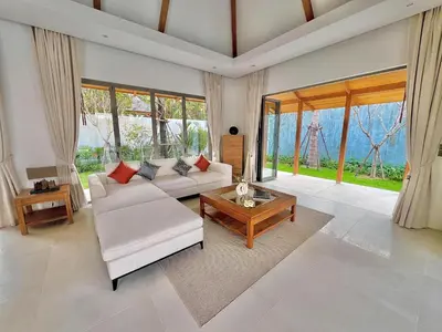 a living room with a couch and a table at New luxury villa with maid Anchan Tropicana in Bang Tao Beach