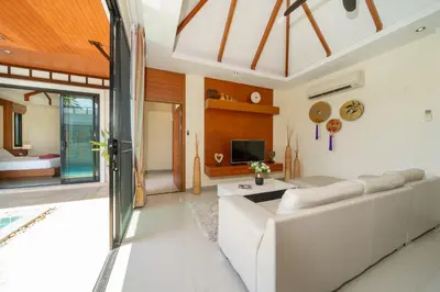 a living room with a white couch and a tv at Private 2BR Pool Villa 2D03 in Gated Residence Rawai VIP Villas in Rawai Beach