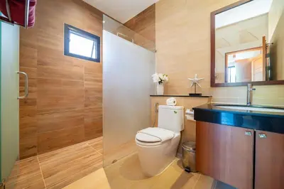 a bathroom with a toilet and a sink at Private 2BR Pool Villa 2D16 in Gated Residences Rawai VIP Villas in Rawai Beach