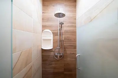 a shower stall in a bathroom with wooden floors at Private 2BR Pool Villa 2D16 in Gated Residences Rawai VIP Villas in Rawai Beach