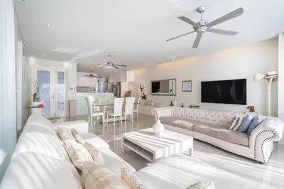 a living room with white furniture and a tv at 13 - Seaside Bliss Overlooking Rawai Beach in Phuket Town