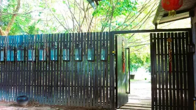 a black fence with a gate with windows at 05 - Exquisite Paradise Retreat in Nai Thon Beach