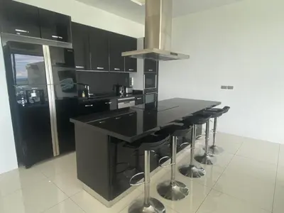 a kitchen with a black counter and a black island at The View Luxury Condominium Karon in Kata Beach
