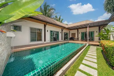 a swimming pool in the backyard of a house at 3 bedrooms private villa with garden Rawai in Phuket Town