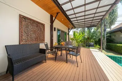 a patio with a table and chairs on a deck at 3 bedrooms private villa with garden Rawai in Phuket Town