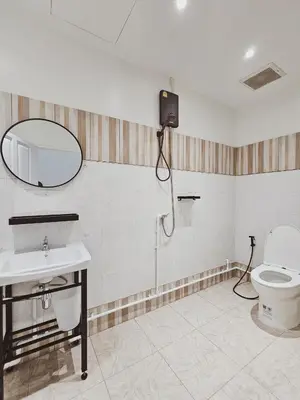 a bathroom with a toilet and a sink and a mirror at Casa Maya House in Phi Phi Don